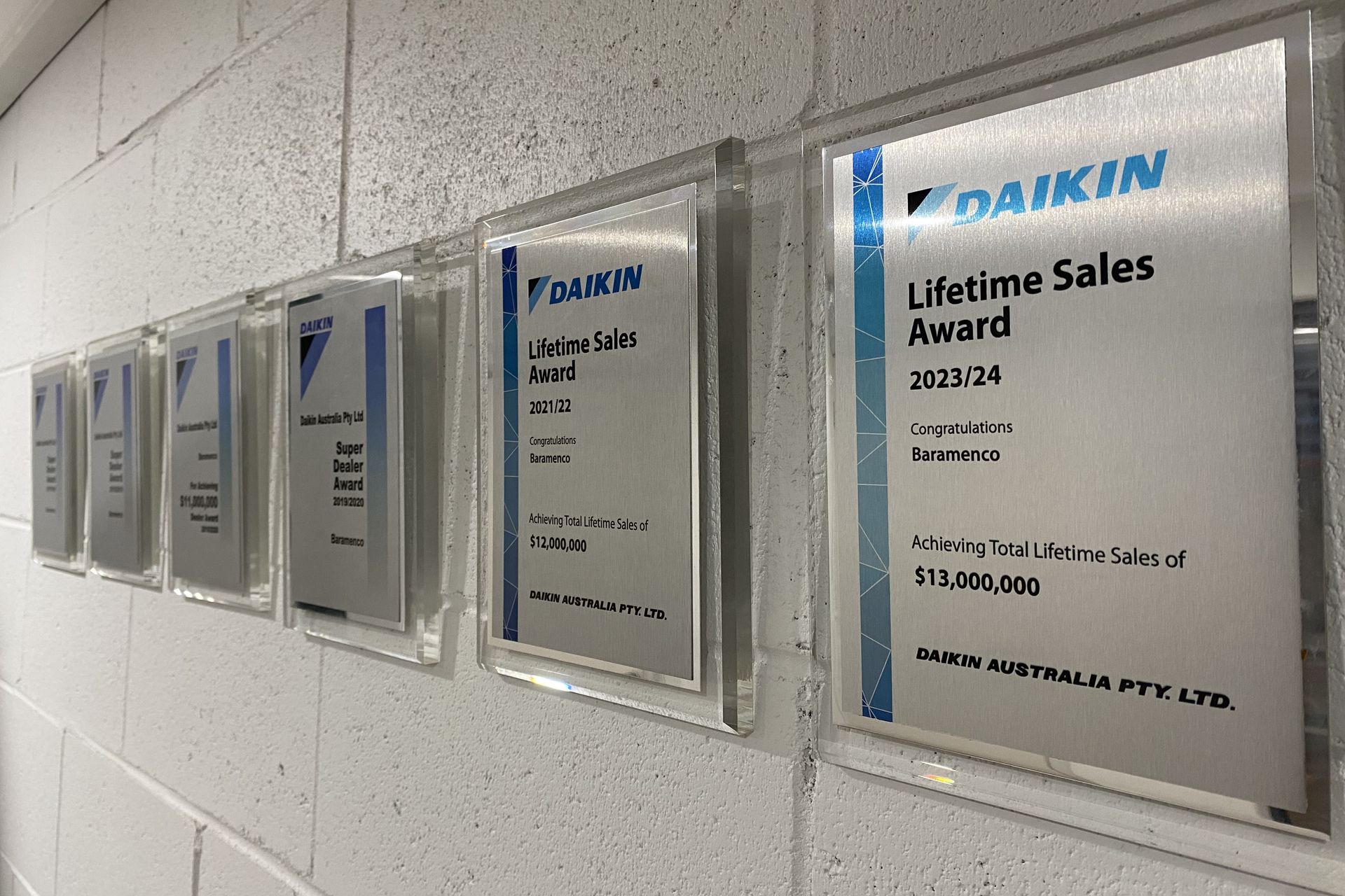 Daikin Super Dealer and Lifetime Sales Award plaques on the wall at Baramenco