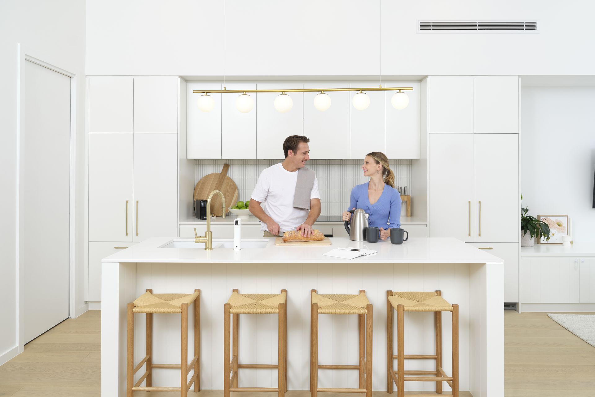 Bright open-plan kitchen with a ducted air conditioning outlet above the island bench